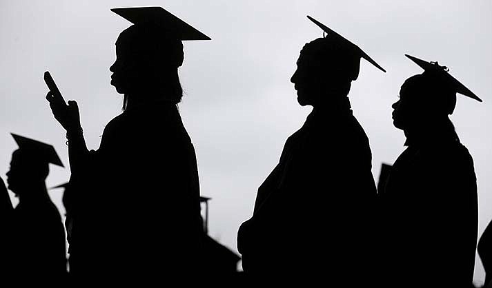 New graduates line up before the start of a community college commencement in East Rutherford, N.J., on May 17, 2018. President Joe Biden announced Wednesday, Aug. 24, 2022 that many Americans can have up to $10,000 in federal student loan debt forgiven. (AP Photo/Seth Wenig, File)