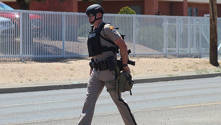 A state trooper is shown outside Kingman High School during a lockdown for a suspected shooter in May, 2022. In a more recent incident, two girls attending the school were suspended and charged with a felony after creating what the Mohave County Sheriff’s Office called a list of individuals they intended to harm. (Miner file photo)