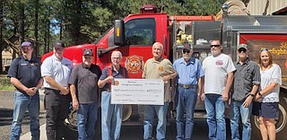 Members of Sherwood Forest Fire District, High Country Fire Rescue and Ponderosa Fire Department accept a donation for new EMS communications equipment from David Dudley and Bob Simoneau of the Sherwood Firefighters Foundation. (Photo/John Moede)