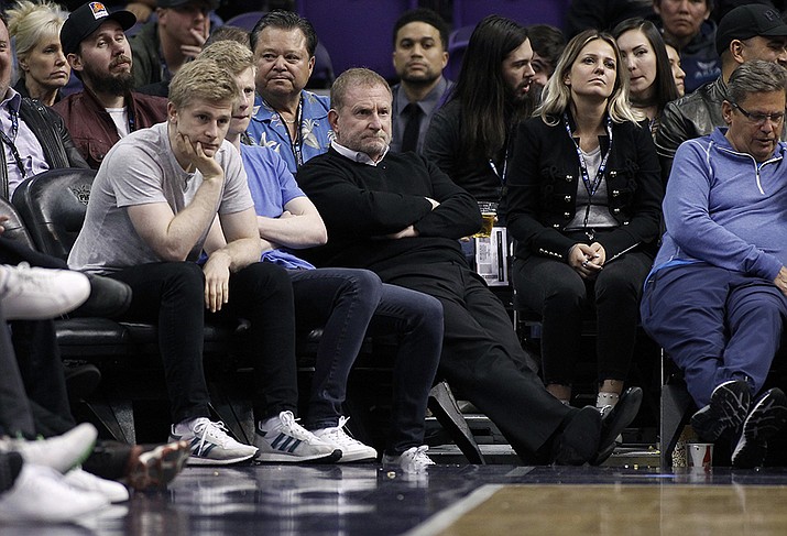 Phoenix Suns owner Robert Sarver, center, watches during the second half of an NBA basketball game against the Minnesota Timberwolves, Saturday, Dec. 15, 2018, in Phoenix. The NBA has suspended Phoenix Suns and Phoenix Mercury owner Robert Sarver for one year, plus fined him $10 million, after an investigation found that he had engaged in what the league called “workplace misconduct and organizational deficiencies." The findings of the league's report, published Tuesday, Sept. 13, 2022, came nearly a year after the NBA asked a law firm to investigate allegations that Sarver had a history of racist, misogynistic and hostile incidents over his nearly two-decade tenure overseeing the franchise. ( Ralph Freso, AP File)