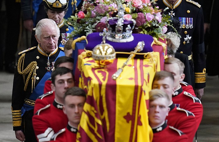 King Charles III and members of the Royal family follow behind the coffin of Queen Elizabeth II, draped in the Royal Standard with the Imperial State Crown and the Sovereign's orb and sceptre, as it is carried out of Westminster Abbey after her State Funeral, in London, Monday Sept. 19, 2022. The Queen, who died aged 96 on Sept. 8, will be buried at Windsor alongside her late husband, Prince Philip, who died last year. (Danny Lawson/Pool Photo via AP)