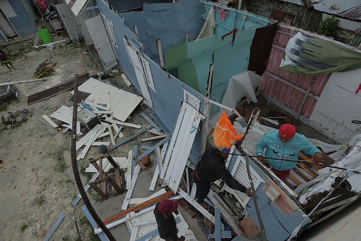 Residents replace a home's roof that was torn off by Hurricane Fiona in the low-income neighborhood of Kosovo in Veron de Punta Cana, Dominican Republic, Monday, Sept. 19, 2022. (Ricardo Hernandez/AP)