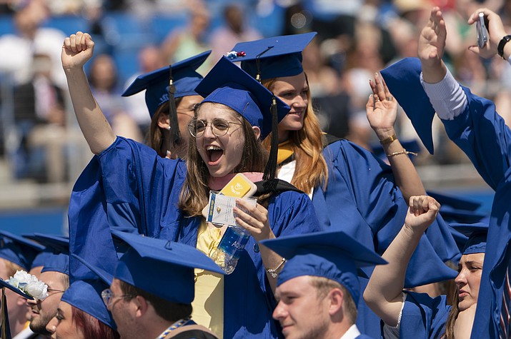 Graduates celebrate during the University of Delaware Class of 2022 commencement ceremony in Newark, Del., Saturday, May 28, 2022. The Department of Education says borrowers who hold eligible federal student loans and have made voluntary payments since March 13, 2020, can get a refund. (Manuel Balce Ceneta/AP)
