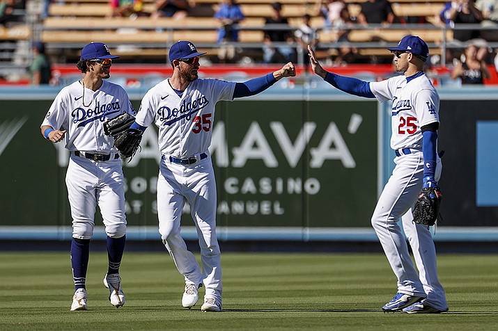 Los Angeles Dodgers' Cody Bellinger (35) celebrates with Trayce Thompson (25) and Miguel Vargas after the Dodgers defeated the Arizona Diamondbacks in a baseball game Tuesday, Sept. 20, 2022, in Los Angeles. (AP Photo/Ringo H.W. Chiu)