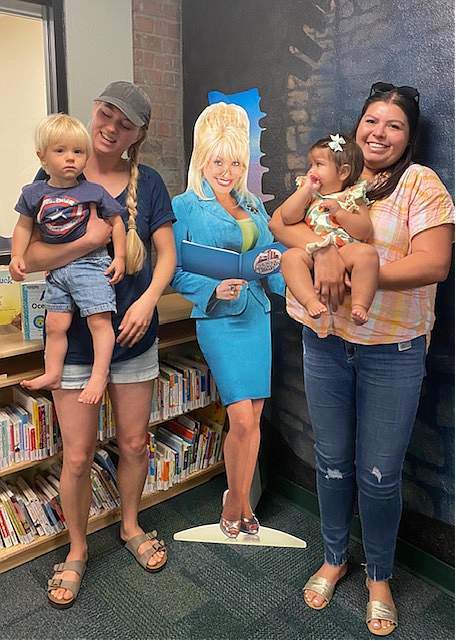 Yavapai County children from birth through age five are eligible for free monthly books through the Imagination Library of the Prescott Area. Several of the parents and children who have participated in the program are pictured here with a cutout of country singer Dolly Parton, whose foundation sponsors the program. Pictured are Theo and Paige Huggins and Natalie Rumsey with daughter Olivia. (Prescott Public Library/Courtesy photo)