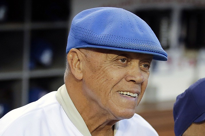 Former Los Angeles Dodgers shortstop Maury Wills is shown before Game 2 of baseball's NL Division Series between the Dodgers and the St. Louis Cardinals in Los Angeles, Saturday, Oct. 4, 2014. Maury Wills, who helped the Los Angeles Dodgers win three World Series titles with his base-stealing prowess, has died. The team says Wills died Monday night, Sept. 19, 2022, in Sedona, Ariz. He was 89. (Jae C. Hong, AP File)