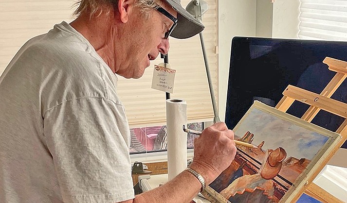 Mike Trulson painting in his kitchen studio