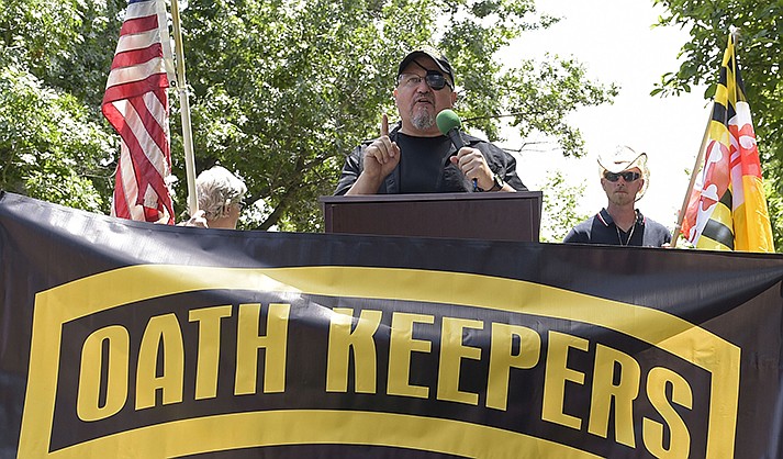 Stewart Rhodes, founder of the Oath Keepers, center, speaks during a rally outside the White House in Washington, June 25, 2017. A new report says that the names of hundreds of U.S. law enforcement officers, elected officials and military members appear on the leaked membership rolls of a far-right extremist group that's accused of playing a key role in the Jan. 6, 2021, riot at the U.S. Capitol. The Anti-Defamation League Center on Extremism pored over more than 38,000 names on leaked Oath Keepers membership lists to find more than 370 people it believes are currently working in law enforcement agencies.(AP Photo/Susan Walsh, File)