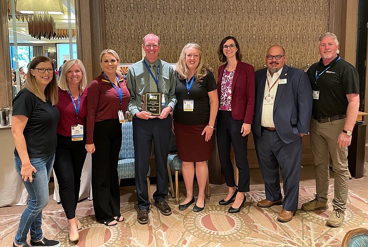 Superintendent John Pothast, fourth from left, receives his award with ASU and state education leaders. Left to right: Leslie Easton, Meg Grothman, Amber Morrow, Mary O’Malley, Arizona Superintendent of Public Instruction Kathy Hoffman, James Vargas and Kurt Palmer. (Shea Johnson, HUSD/Courtesy)