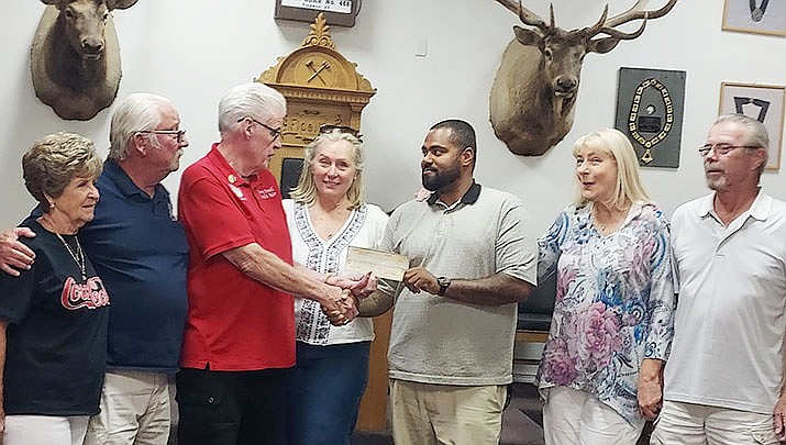 The Kingman Elks in support of the Kingman Area Foodbank presented Ryan Garcia, a check in the amount of $1,861 to supplement the 2,200 pounds of peanut butter collected during the annual Peanut Butter Jam. Pictured from left are Sandra Powell, Fritz McDowell, Jimmy Powell, Laurie McDowell, Ryan Garcia, Debra Odin and Dave Odin. (Kingman Elks courtesy photo)