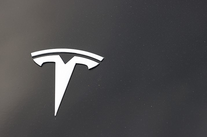 The Tesla company logo is seen on the hood of an unsold vehicle at a dealership, Sunday, Aug. 9, 2020, in Littleton, Colo. Tesla is recalling nearly 1.1 million vehicles in the U.S. because the windows can pinch a person’s fingers when being rolled up. Tesla says in documents posted Thursday, Sept. 22, 2022 by U.S. safety regulators that the automatic window reversal system may not react correctly after detecting an obstruction. (David Zalubowski/AP, File)