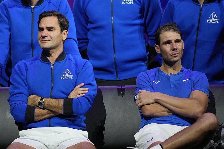 An emotional Roger Federer, left, of Team Europe sits alongside his playing partner Rafael Nadal after their Laver Cup doubles match against Team World's Jack Sock and Frances Tiafoe at the O2 arena in London, Friday, Sept. 23, 2022. Federer's losing doubles match with Nadal marked the end of an illustrious career that included 20 Grand Slam titles and a role as a statesman for tennis. (Kin Cheung/AP)