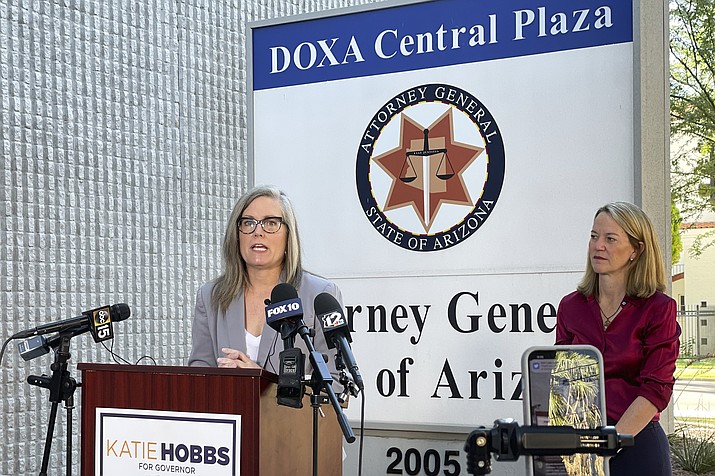 Arizona Secretary of State Latie Hobbs, left, the Democratic nominee for governor, and Kris Mayes, a Democrat running for attorney general, speak to reporters outside the Arizona Attorney General's Office in Phoenix on Saturday, Sept. 24, 2022. (Jonathan J. Cooper/AP)