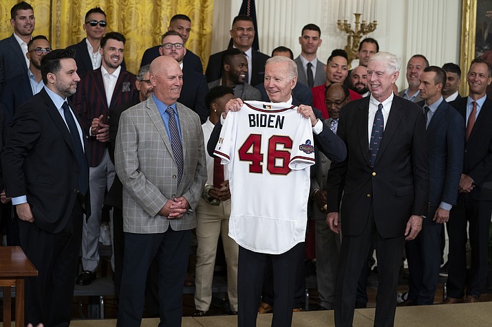 President Joe Biden holds up a jersey during an event celebrating the 2021 World Series champion Atlanta Braves, in the East Room of the White House, Monday, Sept. 26, 2022, in Washington. From left, Braves President of Baseball Operations Alex Anthopoulos, manager Brian Snitker, Biden, and Braves President and CEO Terry McGuirk. (Evan Vucci/AP)