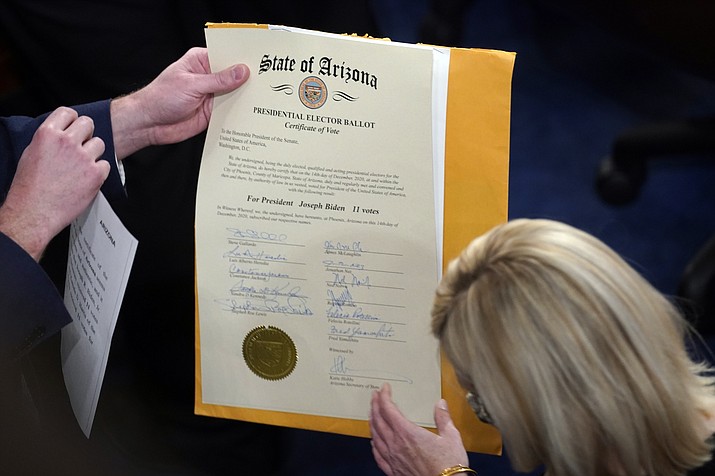 The certification of Electoral College votes for the state of Arizona is unsealed during a joint session of the House and Senate convenes to confirm the electoral votes cast in November's election, at the Capitol, Jan 6, 2021. Members of Congress have officially objected to the results in four of the last six presidential elections, a partisan practice that has been legal for over a century but became much more fraught after a violent mob of former President Donald Trump’s supporters attacked the Capitol last year. (Andrew Harnik/AP, File)