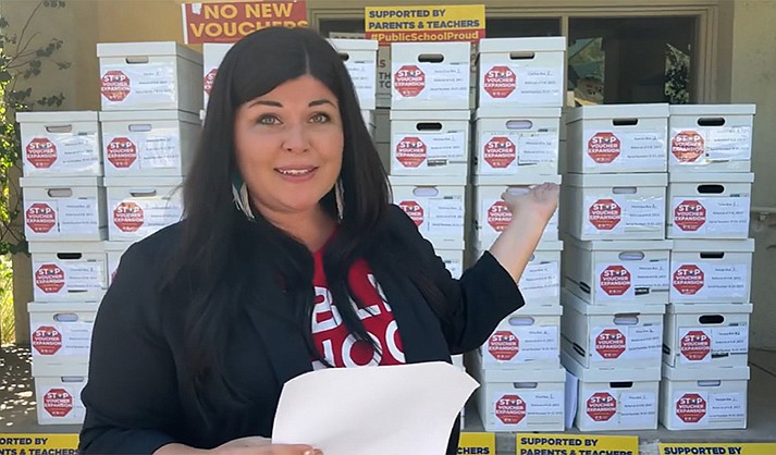 Beth Lewis of Save Our Schools Arizona with boxes of petitions that she said had more than 140,000 signatures to halt the state’s expanded Empowerment Scholarship Accounts. That turned out not to be the case. (Photo courtesy Save Our Schools Arizona)