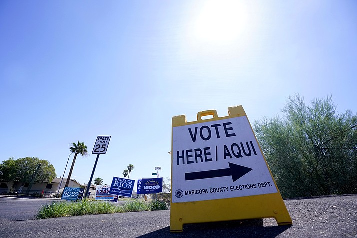 A where-to-vote sign points voters in the direction of the polling station as the sun beats down as Arizona voters go the polls to cast their ballots, Tuesday, Aug. 2, 2022, in Phoenix. (Ross D. Franklin/AP)