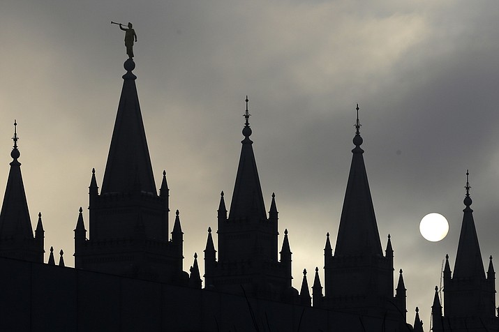 The angel Moroni statue atop the Salt Lake Temple is silhouetted against a cloud-covered sky, at Temple Square in Salt Lake City on Feb. 6, 2013. (Rick Bowmer/AP, File)