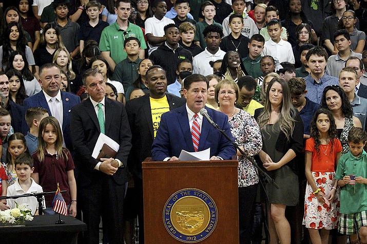 Arizona Gov. Doug Ducey speaks at an event touting a new universal school voucher program he signed into law in July and resigned again in a ceremony on Tuesday, Aug. 16, 2022 at Phoenix Christian Preparatory School in Phoenix, Ariz. All Arizona parents now can use state tax money to send their children to private or religious schools or pay homeschooling costs after an effort by public school advocates to block a massive expansion of the state's private school voucher law failed to collect enough signatures to block the law. (Bob Christie, AP File)