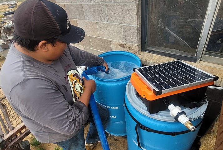 The organization Antinanco partnered with K’eh Native Action to install more solar water pumps to remote homes on the Navajo and Hopi reservations in September. Workers and volunteers (below) take a break while installing the pumps. (Photos/Bitahnii Wilson/Antinanco)