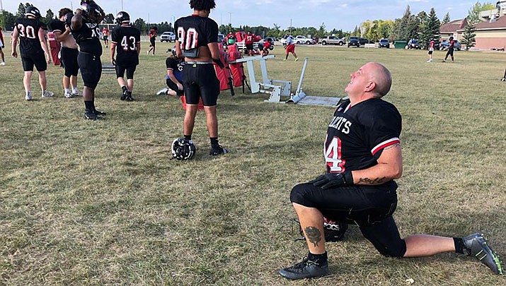 Ray Ruschel, a 49-year-old freshman football player for the North Dakota State College of Science, takes his turn on the blocking sled on Tuesday, Sept. 20, 2022, in Wahpeton, N.D. Ruschel had not played football since he was in high school in Pennsylvania. (Dave Kolpack/AP)