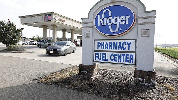 In this June 26, 2019, file photo a customer exits a Kroger fueling center in Flowood, Miss. Two of the nation’s largest grocers have agreed to merge in a deal that would help them better compete with Walmart, Amazon and other major companies that have stepped into the grocery business. Kroger on Friday, Oct. 14, 2022 bid $20 billion for Albertsons Companies Inc., or $34.10 per share. ( Rogelio V. Solis, AP File)