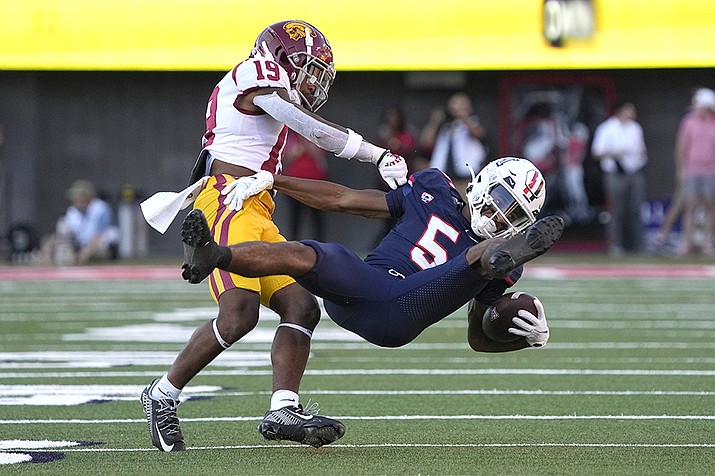Southern California defensive back Jaylin Smith (19) tackles Arizona wide receiver Dorian Singer for a loss in the first half during an NCAA college football game, Saturday, Oct. 29, 2022, in Tucson, Ariz. (Rick Scuteri/AP)