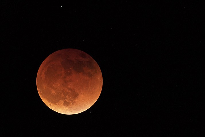 The moon is shown during a full lunar eclipse, Sunday, May 15, 2022, near Moscow, Idaho, with the reddish color caused by it passing into the shadow of the Earth. A Tuesday, Nov. 8, 2022 total lunar eclipse will be visible throughout North America in the predawn hours ... the farther west, the better --- and across Asia, Australia and the rest of the Pacific after sunset. (Ted S. Warren/AP, File)