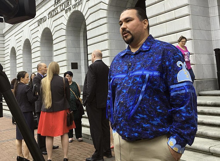 Tehassi Hill, tribal chairman of the Oneida Nation, stands outside a federal appeals court in New Orleans, following arguments on the constitutionality of a 1978 law giving Native American families preference in adoption of Native American children. The U.S. Supreme Court will hear arguments, Wednesday, Nov. 9, 2022 on the most significant challenge to the Indian Child Welfare Act that gives preference to Native American families in foster care and adoption proceedings of Native American children since it passed in 1978. (AP Photo/Kevin McGill, File)