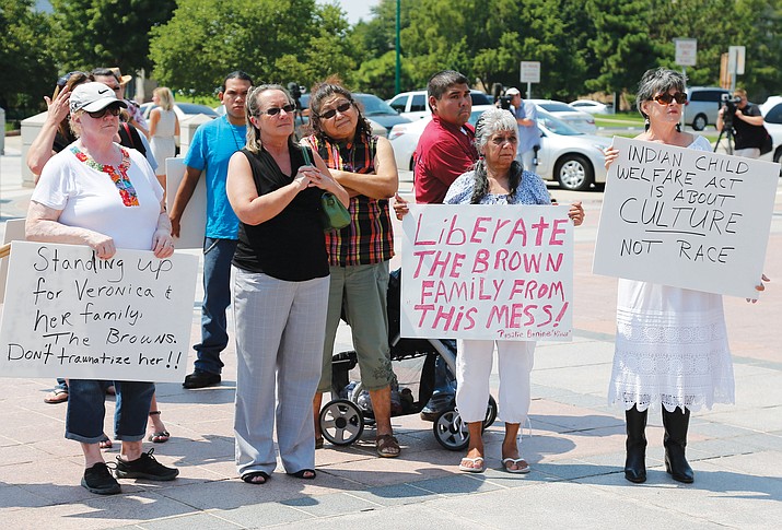 Participants listen during a rally in support of three-year-old baby Veronica, Veronica's biological father, Dusten Brown, and the Indian Child Welfare Act, in Oklahoma City, Aug. 19, 2013. (Photo/ Sue Ogrocki Associated Press)