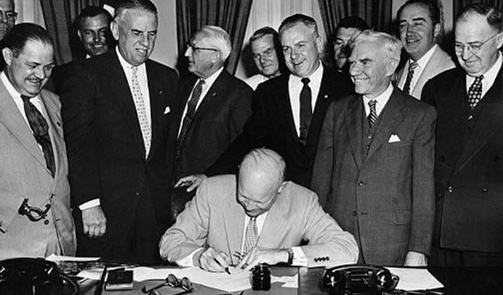 President Dwight D. Eisenhower signs HR7786, June 1, 1954. This ceremony changed Armistice Day to Veterans Day.
