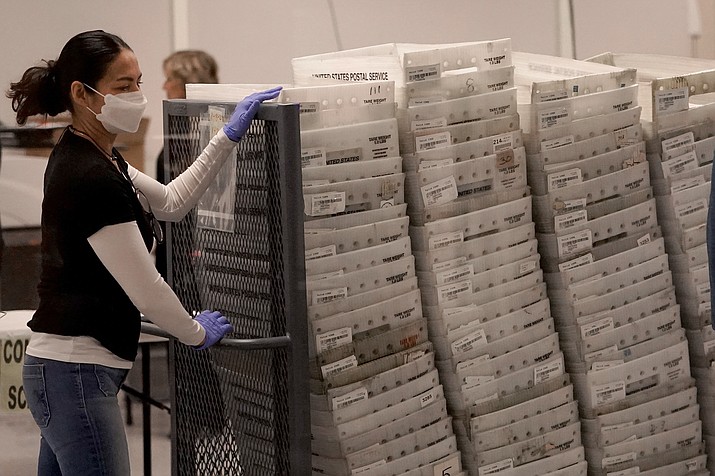 An election worker boxes tabulated ballots inside the Maricopa County Recorders Office, Wednesday, Nov. 9, 2022, in Phoenix. (Matt York/AP)