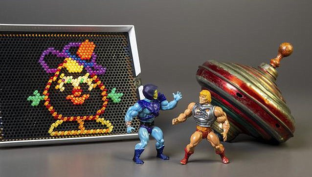 This undated photo shows the three toys inducted into the National Toy Hall of Fame on Nov. 10, 2022, in Rochester, N.Y. Masters of the Universe, Lite-Brite and the top were chosen from among 12 finalists for the annual honor, which recognizes toys that have inspired creative play and lasting popularity. (Courtesy of The Strong Museum via AP)