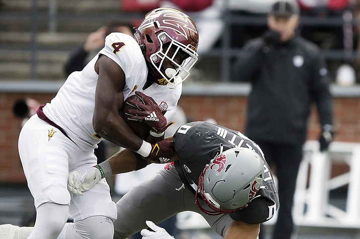Arizona State running back Daniyel Ngata (4) tries to get past Washington State defensive back Sam Lockett III (0) during the first half of an NCAA college football game, Saturday, Nov. 12, 2022, in Pullman, Wash. (Young Kwak/AP)