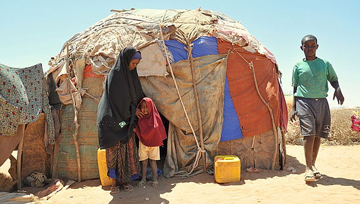 A family displaced by drought is shown outside their shelter in Somaliland in East Africa. Battling droughts, sandstorms, floods, wildfires, coastal erosion, cyclones and other weather events exacerbated by climate change, the African continent needs to adapt, but it needs funds to do so, leaders and negotiators from the continent said at the U.N. climate summit. (Photo by https://bit.ly/3Equaa7)