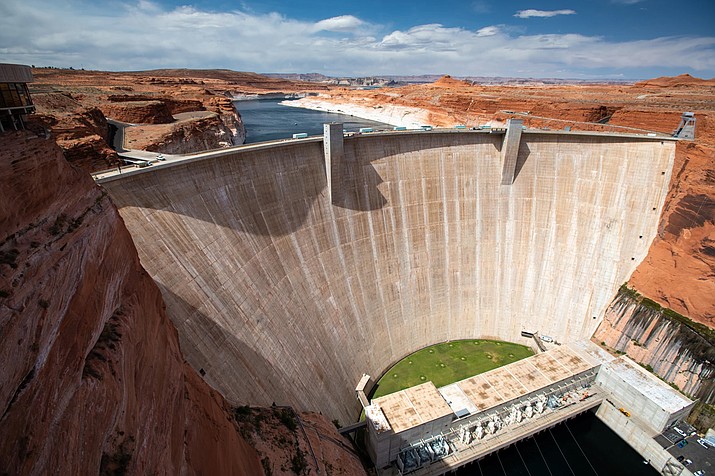 Water levels are at record lows and still dropping in the nations largest reservoirs. The federal government began the process of restricting water releases from Glen Canyon Dam, which holds back a shrinking Lake Powell (Photo/Ted Woodl/The Water Desk)