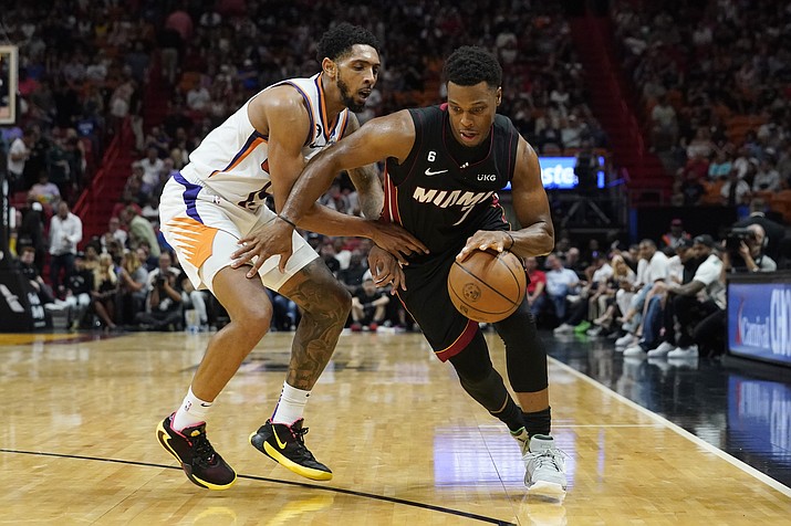 Miami Heat guard Kyle Lowry (7) dribbles around Phoenix Suns guard Cameron Payne (15) during the first half of a game Monday, Nov. 14, 2022, in Miami. (Marta Lavandier/AP)