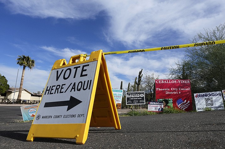 A voting sign points voters in the right direction to drop off ballots in Phoenix, Monday, Nov. 7, 2022. (Ross D. Franklin/AP)
