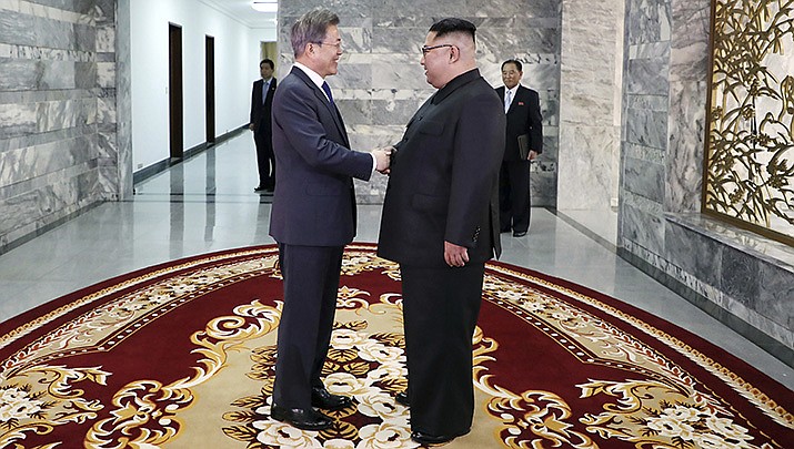 North Korean leader Kim Jong Un, right, and South Korean President Moon Jae-in, left, shake hands. North Korea fired an intercontinental ballistic missile that landed near Japanese waters Friday. (South Korea Presidential Blue House/Yonhap via AP)