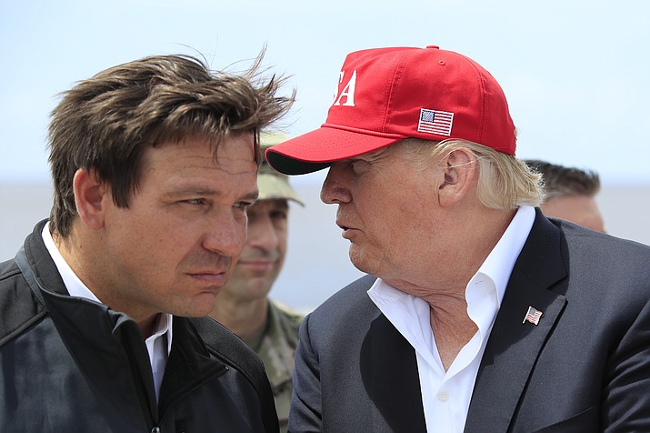 President Donald Trump talks to Florida Gov. Ron DeSantis, left, during a visit to Lake Okeechobee and Herbert Hoover Dike at Canal Point, Fla., March 29, 2019. Republican 2024 presidential prospects descend upon Las Vegas this weekend as anxious donors and activists openly consider whether to embrace former President Donald Trump for a third consecutive run for president. Trump will be among the only major Republican prospects not in attendance for the Republican Jewish Coalition’s annual leadership meeting. (Manuel Balce Ceneta/AP, File)