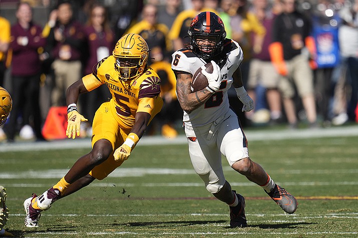 Oregon State running back Damien Martinez (6) runs past Arizona State defensive back Chris Edmonds (5) during the first half of an NCAA college football game in Tempe, Ariz., Saturday, Nov. 19, 2022. (Ross D. Franklin/AP)
