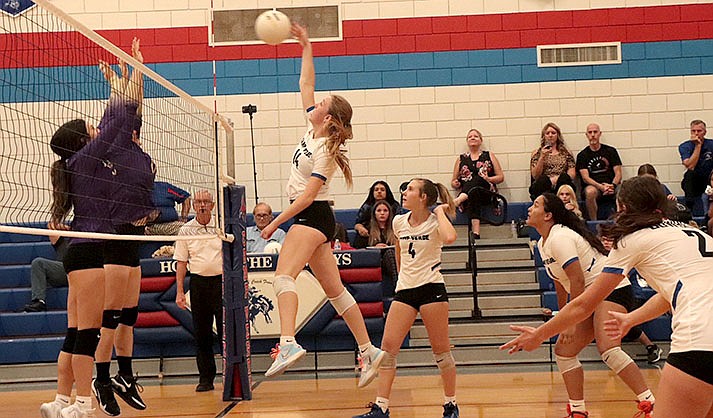 Graves goes up for the spike as opponents attempt to block her shot. (Camp Verde HS Yearbook staff photo)