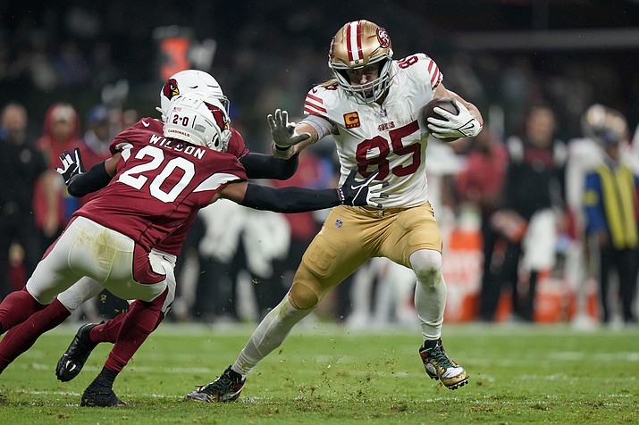San Francisco 49ers tight end George Kittle, right, gets past Arizona Cardinals cornerback Marco Wilson (20) and safety Budda Baker, on his way to scoring a touchdown during the first half of a game Monday, Nov. 21, 2022, in Mexico City. (Fernando Llano/AP)