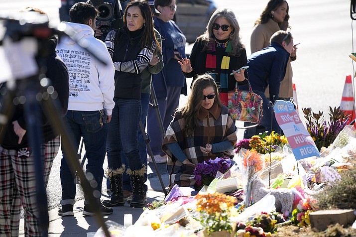 Bouquets of flowers sit on a corner near the site of a mass shooting at a gay bar Monday, Nov. 21, 2022, in Colorado Springs, Colo. Club Q on its Facebook page thanked the "quick reactions of heroic customers that subdued the gunman and ended this hate attack.” (David Zalubowski/AP)
