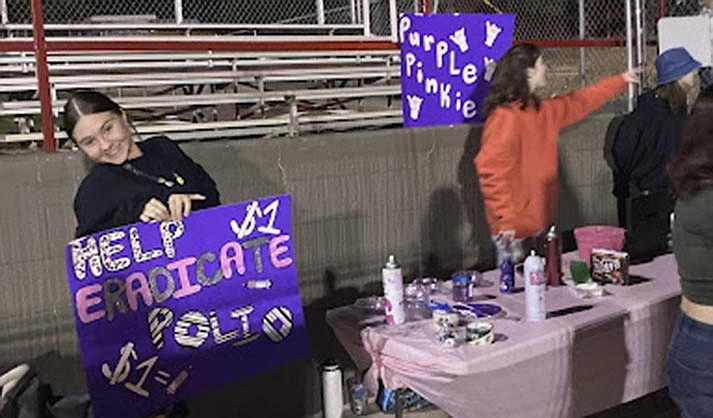 Sophomore Vice President Brooklyn Colvin collecting funds for Purple Pinkie table at the Homecoming game last month. (Courtesy/Susanna Ventura)