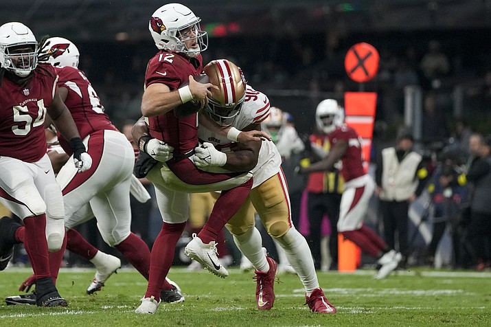 Arizona Cardinals quarterback Colt McCoy is sacked by San Francisco 49ers defensive tackle Kevin Givens during the second half of a game Monday, Nov. 21, 2022, in Mexico City. (Eduardo Verdugo/AP)