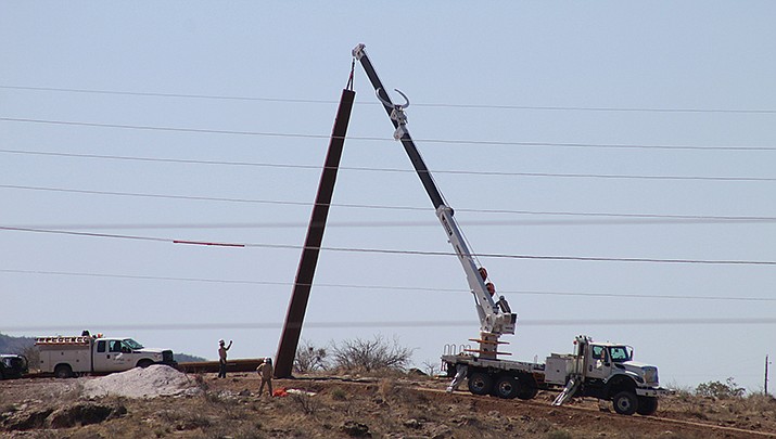 UniSource is seeking an electric rate increase. A crew installs a power pole in Kingman this past March. (Miner file photo)
