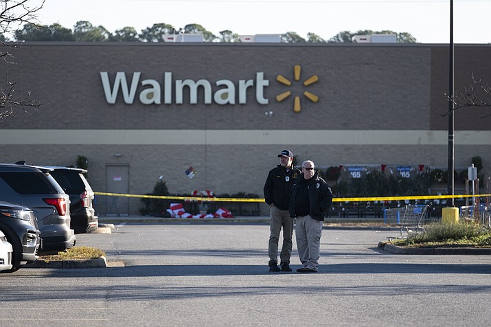 Police wait outside a Walmart in Chesapeake, Va. on Wednesday, Nov. 23, 2022, where the night before a mass shooting took place. (Billy Schuerman/The Virginian-Pilot via AP)
