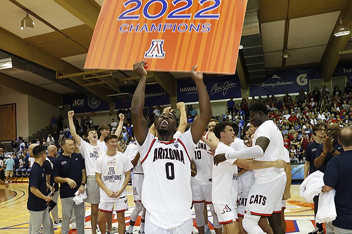 Arizona guard Courtney Ramey (0) holds a poster after Arizona defeated Creighton 81-79 in an NCAA college basketball game, Wednesday, Nov. 23, 2022, in Lahaina, Hawaii. (Marco Garcia/AP)