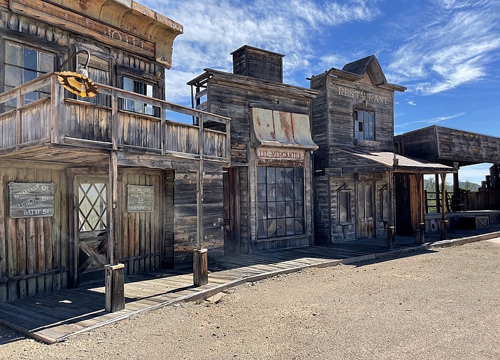 A variety of facades along Main Street in Old Tucson advertise eateries and general stores that have been in such notable films as “Tombstone” and “Rio Bravo.” Photo taken Oct. 21, 2022. (Paloma Garcia/Cronkite News)